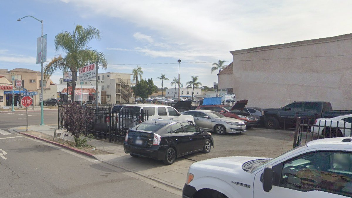 Vo's Auto Repair lot and billboard at 5051 El Cajon Blvd, at the corner of Altadena Ave